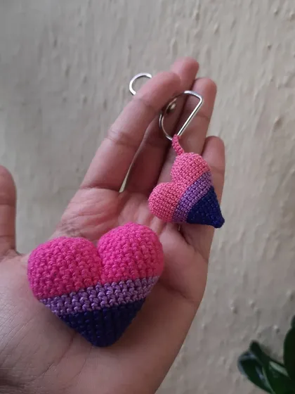 These bisexual pride hearts are shown as a large plushie and a small keychain. You can get matching items in different sizes.