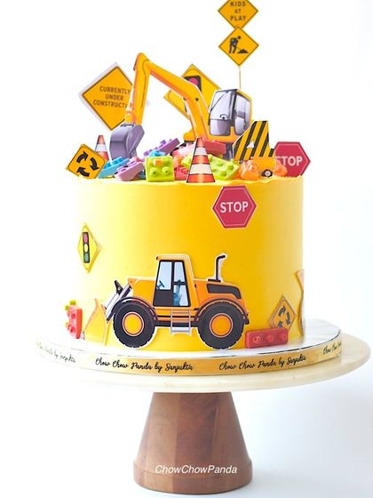 A straight-on view of the construction and Lego cake, showing the excavator and bulldozer details.