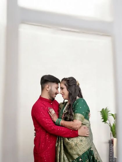 An intimate portrait of the couple, framed by the white architecture of a doorway. This use of natural framing draws the viewer's eye directly to their close and loving embrace.