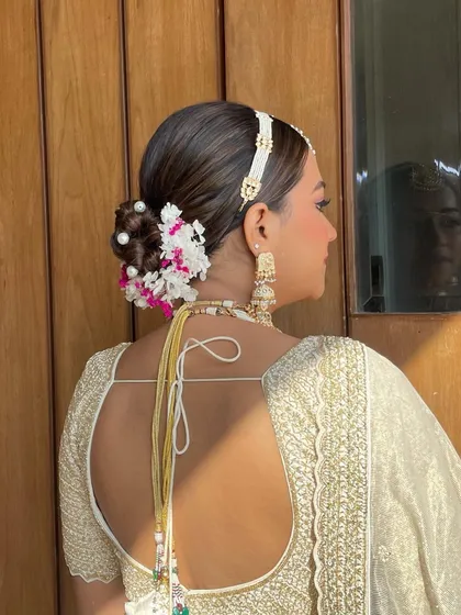 A side profile of the stunning pearl and hydrangea bridal updo.