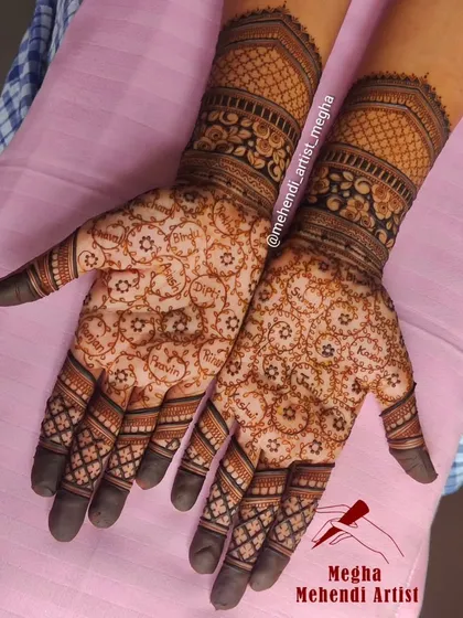 This engagement mehendi is truly personal, with the names of beloved family members delicately written within the circular patterns on the palms.