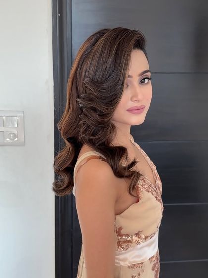 The front fall says it all. This hairstyle features beautifully sculpted waves framing the face, a technique that adds a touch of vintage glamour to any look.