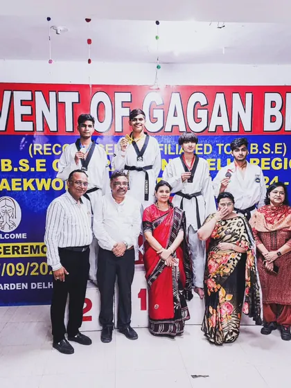 A group photo with officials and my winning students at the CBSE Central Zone Taekwondo Championship.
