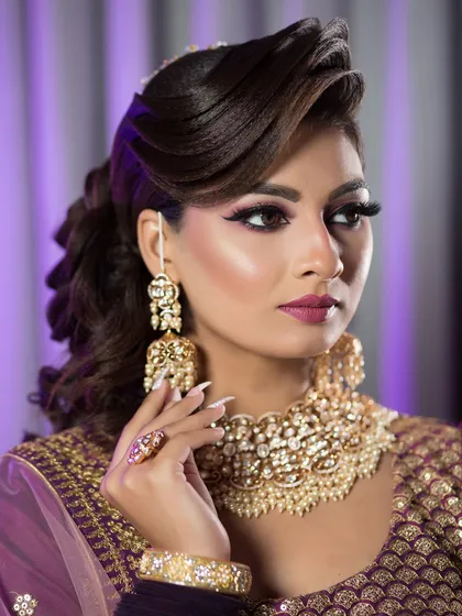 This is a glamorous reception or engagement look. I created a dramatic winged eyeliner and a bold lip, paired with a sculpted, voluminous hairstyle that is perfect for an evening celebration.