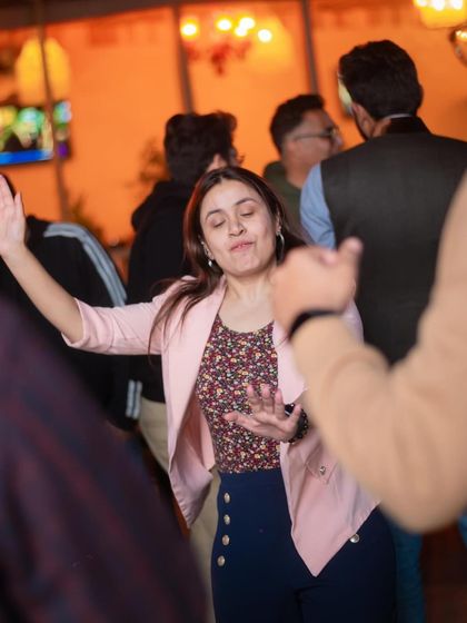 A guest raising her hand to the beat, completely immersed in the party atmosphere.