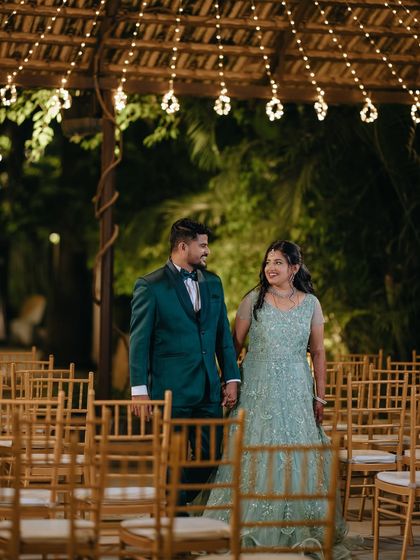 A candid shot of the couple walking through their reception venue, hand in hand, sharing a private moment before greeting their guests.