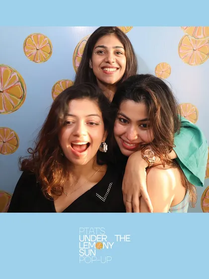 A group of friends squeezing in for a photo at the PTAT pop-up. Our booth is all about capturing the fun of friendship.