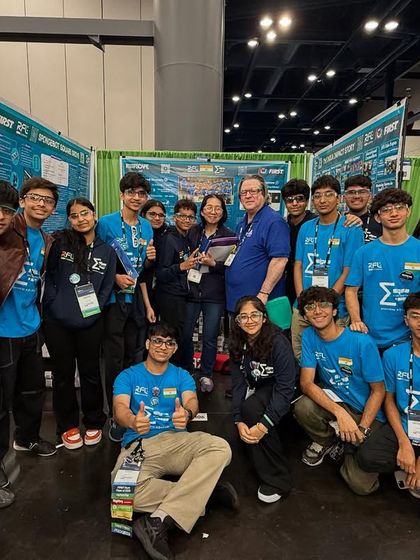 Team Sigma poses with a judge at the FIRST World Championship, a moment of recognition for their hard work and outreach efforts.