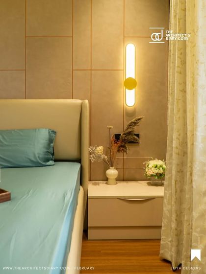 The serene bedroom from the Anagha project, with its minimalist bedside setup and warm lighting, as featured in the publication.