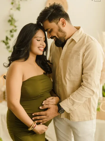 An intimate moment between expecting parents during their boho maternity shoot. The soft lighting and close embrace perfectly capture the love and connection they share.