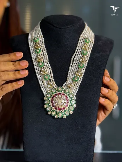 The beauty of a heritage piece lies in its details. This traditional polki necklace, with its intricate floral medallion and strings of pearls, is a perfect example of timeless design. It’s crafted to be an evergreen treasure for a bridal trousseau.