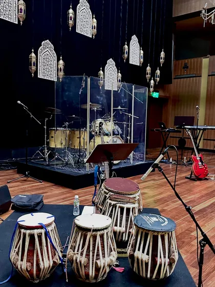 The view from my seat on stage. My tablas are in the foreground, with the drum kit and other instruments ready for the show to begin.