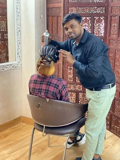 Here I am putting the finishing touches on a stylish, modern updo. This look combines sleek lines with textured elements for a very chic result.