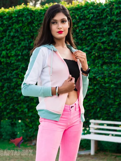 An example of an outdoor lifestyle shoot for a casual apparel brand. Using natural light and a simple green background, this image has a fresh, commercial feel that highlights the product in a relatable setting.