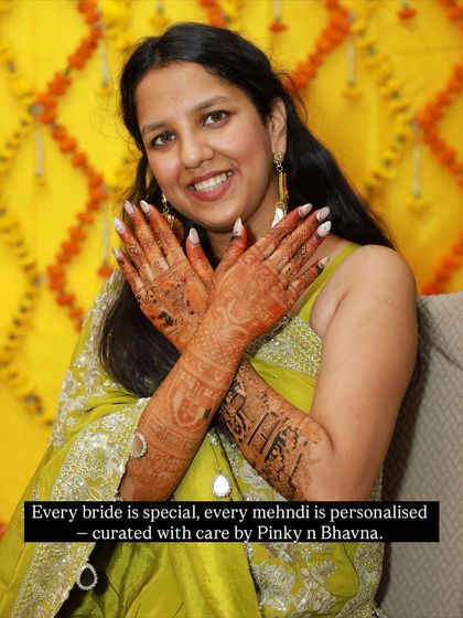 Every bride is special, and every mehndi is personalized. This smiling bride showcases her unique design, curated with care.