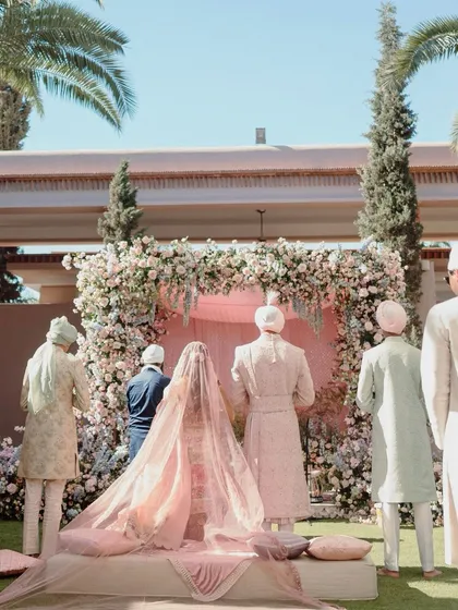 The Anand Karaj ceremony, a moment of soft serenity in Marrakech. We used a palette of soft pinks and lilacs, with a canopy of cascading flowers, to create a sacred space that felt peaceful and ethereal.