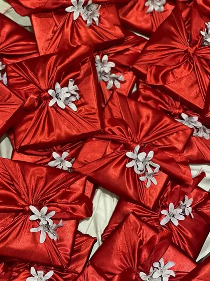 These beautiful red furoshiki-wrapped gifts were part of a large corporate order for Women's Day. This sustainable wrapping technique adds a touch of elegance and care.