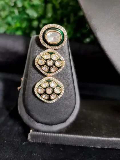 The matching earring, featuring three circular kundan elements for a contemporary feel.