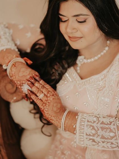 A close-up on the bride's hands, showcasing her beautiful henna and engagement ring. It's these small, detailed shots that help tell the complete story of the day.