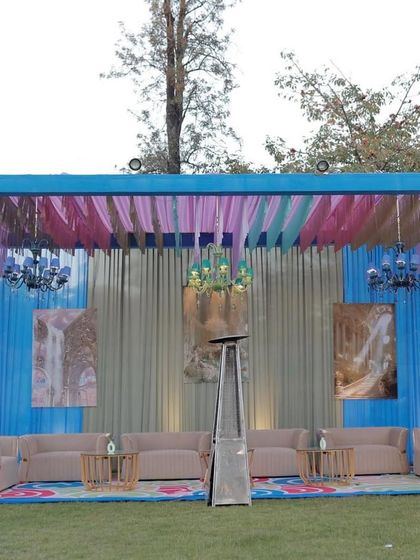 A comfortable and stylish seating lounge set up for guests at the outdoor carnival party.