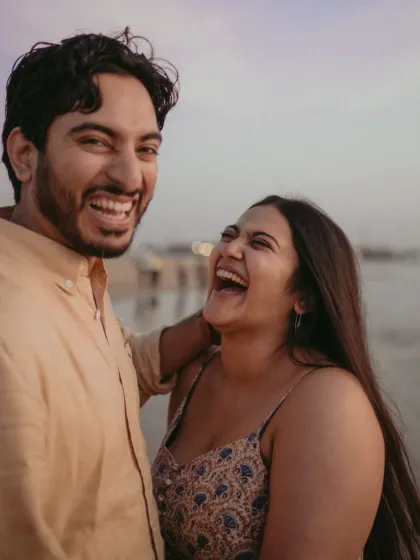 A close-up filled with infectious laughter. This candid shot captures the pure joy and fun of a day spent by the sea, reflecting a genuine and happy connection.