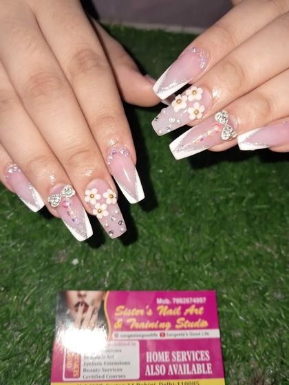 A beautiful and elegant set for a special occasion. These long coffin nails feature a French ombre base with delicate 3D flowers and sparkling stone bows.