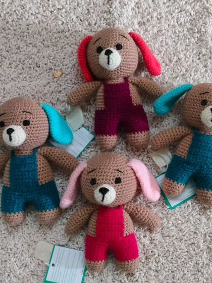 These cute puppies are all wearing different colored overalls. They are ready to be shipped to their new homes.