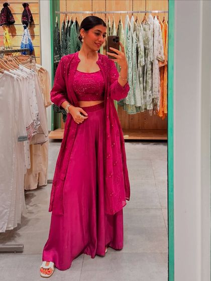 The same magenta co-ord set styled with a matching jacket, showing how layering can add another dimension to your festive look.