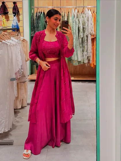 The same magenta co-ord set styled with a matching jacket, showing how layering can add another dimension to your festive look.