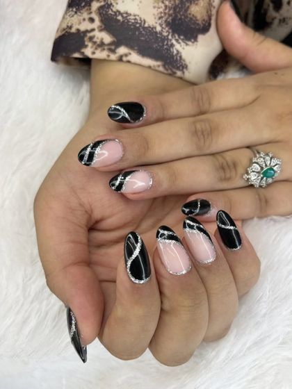 A sophisticated black and silver design. This look features abstract black shapes on a sheer base, outlined with a fine line of silver glitter for a touch of sparkle.
