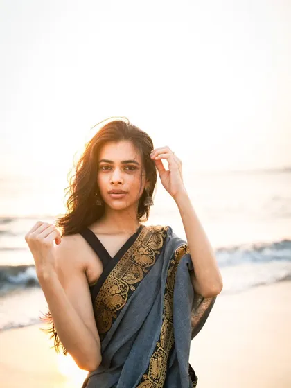 A beautiful sunset portrait in a saree. The golden light, known as the golden hour, creates a warm, magical glow and a soft silhouette.