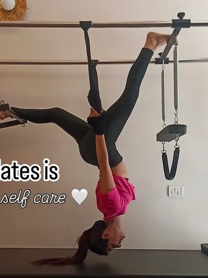An inverted stretch on the Cadillac, showing the playful and therapeutic side of Pilates. It's about finding new ways to move and care for your body.