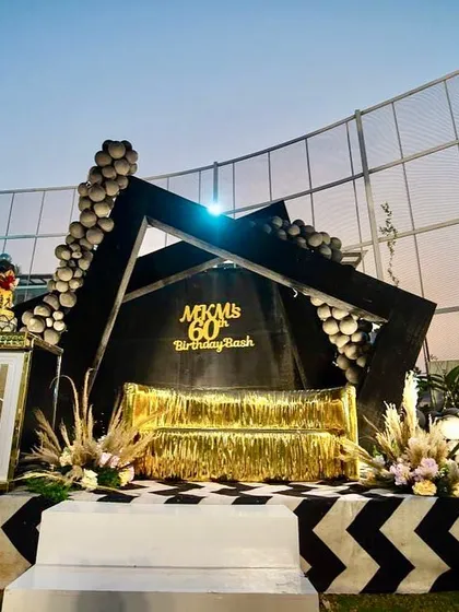 The striking geometric stage we designed and built for a modern 60th birthday celebration.