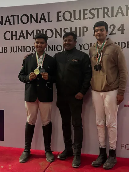 Two of our young riders with their coach, showcasing a haul of medals from the Junior National Equestrian Championship. Their success spans dressage, eventing, and show jumping.