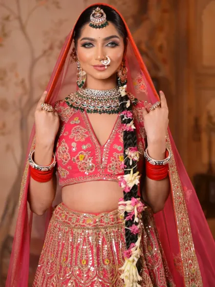 The bride adjusts her dupatta, giving a glimpse of her complete look. The makeup is designed to be stunning from every angle, ensuring she looks perfect throughout her special day.
