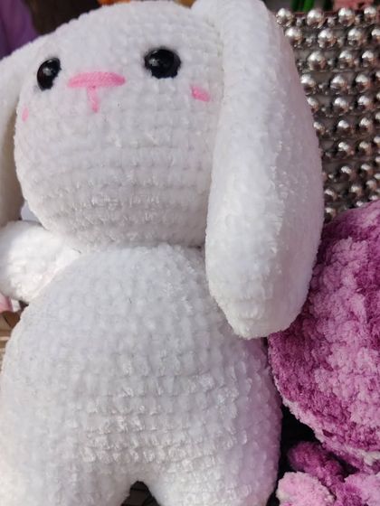 A close-up of the bunny's sweet, hand-stitched face.