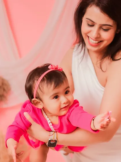 A mother's love shining through. Her smile as she holds her daughter is simply beautiful.