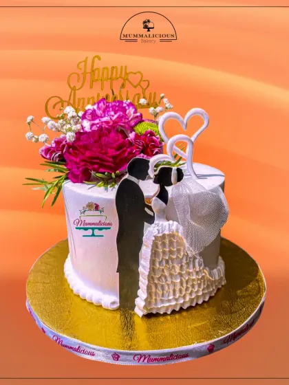 A modern and romantic anniversary cake. The silhouette of a couple, combined with fresh flowers and delicate heart toppers, creates a beautiful and personal way to celebrate another year of love.