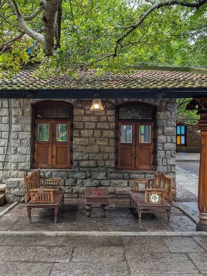 This stone structure, nestled under a sprawling tree, is one of the many corners filled with old-world charm, perfect for intimate seating or a quiet photo opportunity.