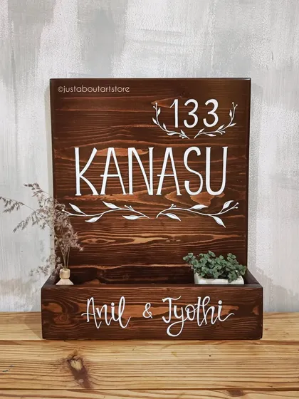 Another look at the "Kanasu" name plaque, showing the depth of the planter box and the beautiful contrast of the white lettering on the dark wood.