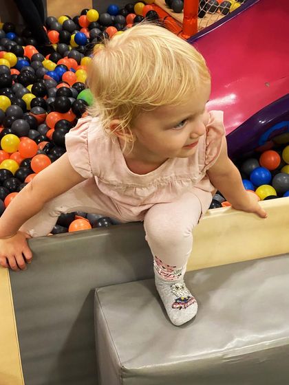Taking a brave step into the ball pit! Our soft, padded edges make it easy and safe for toddlers to climb in and out on their own.