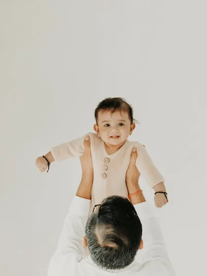 The world looks different from up here. I love capturing the dynamic and playful moments between a parent and child. This image of a father lifting his baby high is full of happiness and trust, a perfect memory from a family portrait session in my Noida studio.