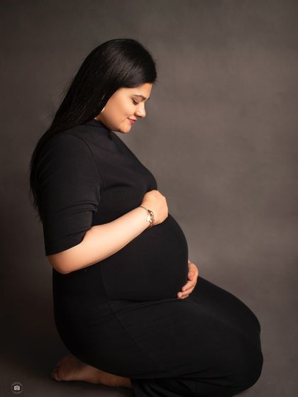 A kneeling solo portrait in black and white. This pose offers a different perspective while maintaining a classic and graceful look.