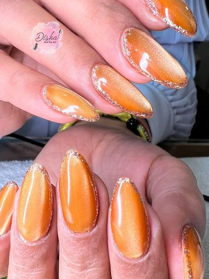 A vibrant orange cat eye design with a sparkling glitter outline.