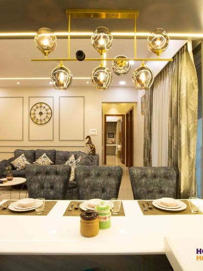 The dining area overlooks the living room, but the statement chandelier clearly defines the kitchen and dining space.