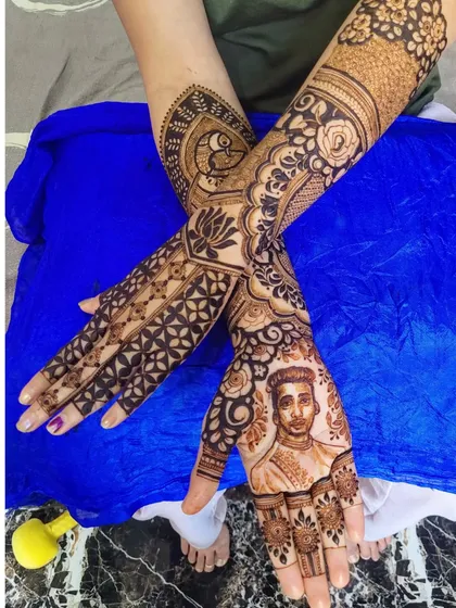 A look at the full design, showing how the portrait on the palm connects with the peacock and floral motifs wrapping around the arm.