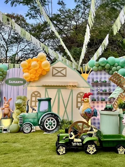 For this charming barnyard party, I combined large-scale props like a barn and tractor with adorable animal figures and balloon garlands to create a fun farm experience.