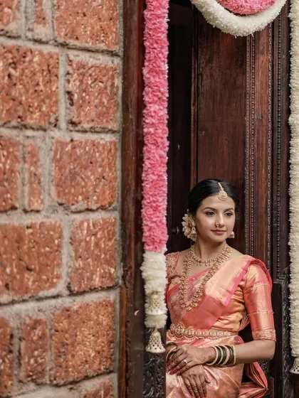 Another angle of the bride in the traditional doorway. The soft lighting is perfect for showing off the subtle glow of her makeup.