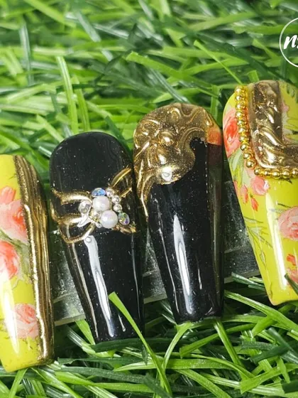 A showcase of embossed chrome techniques, combining rich black and vibrant yellow gel polish. These designs feature intricate 3D chrome details, floral painting, and pearl accents for a truly opulent look.
