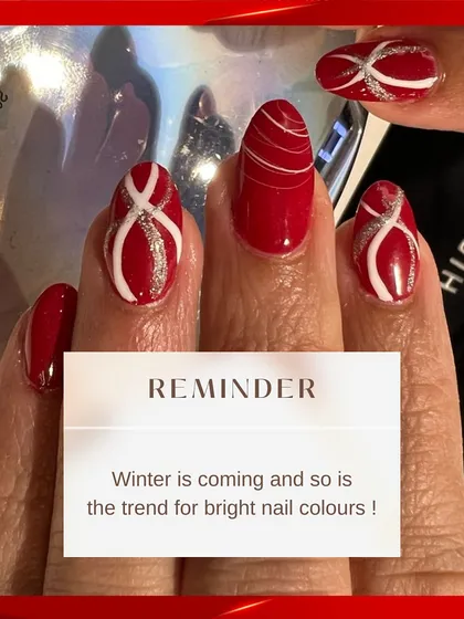 A reminder that winter is a great time for bright nail colors. This close-up shows the detail in the swirling white lines and the subtle silver sparkle on the red base.